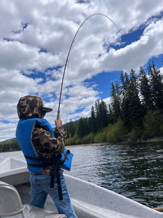 Young child learning to fly fish