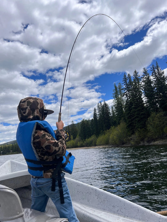 Young child learning to fly fish