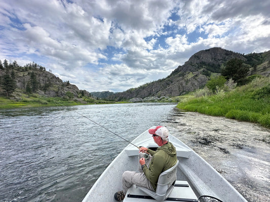 Angler fishing from a drift boat on the river