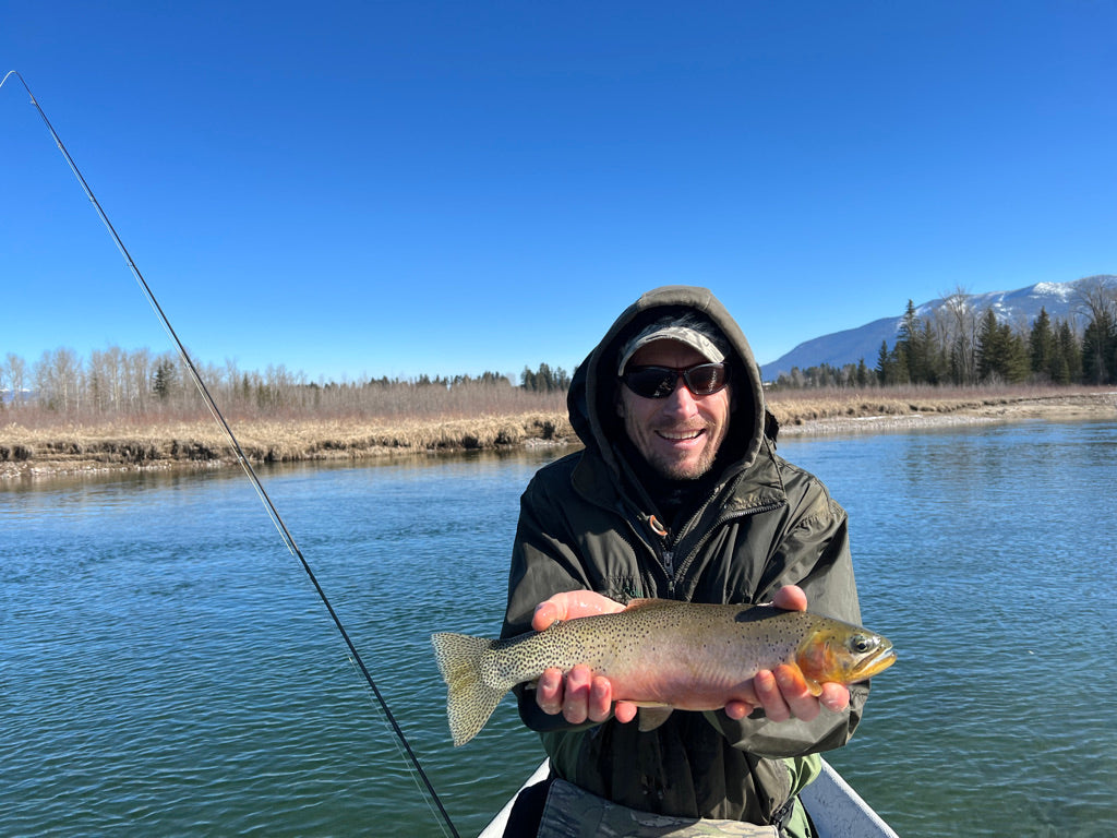 man holding cutthroat trout on the flathead river
