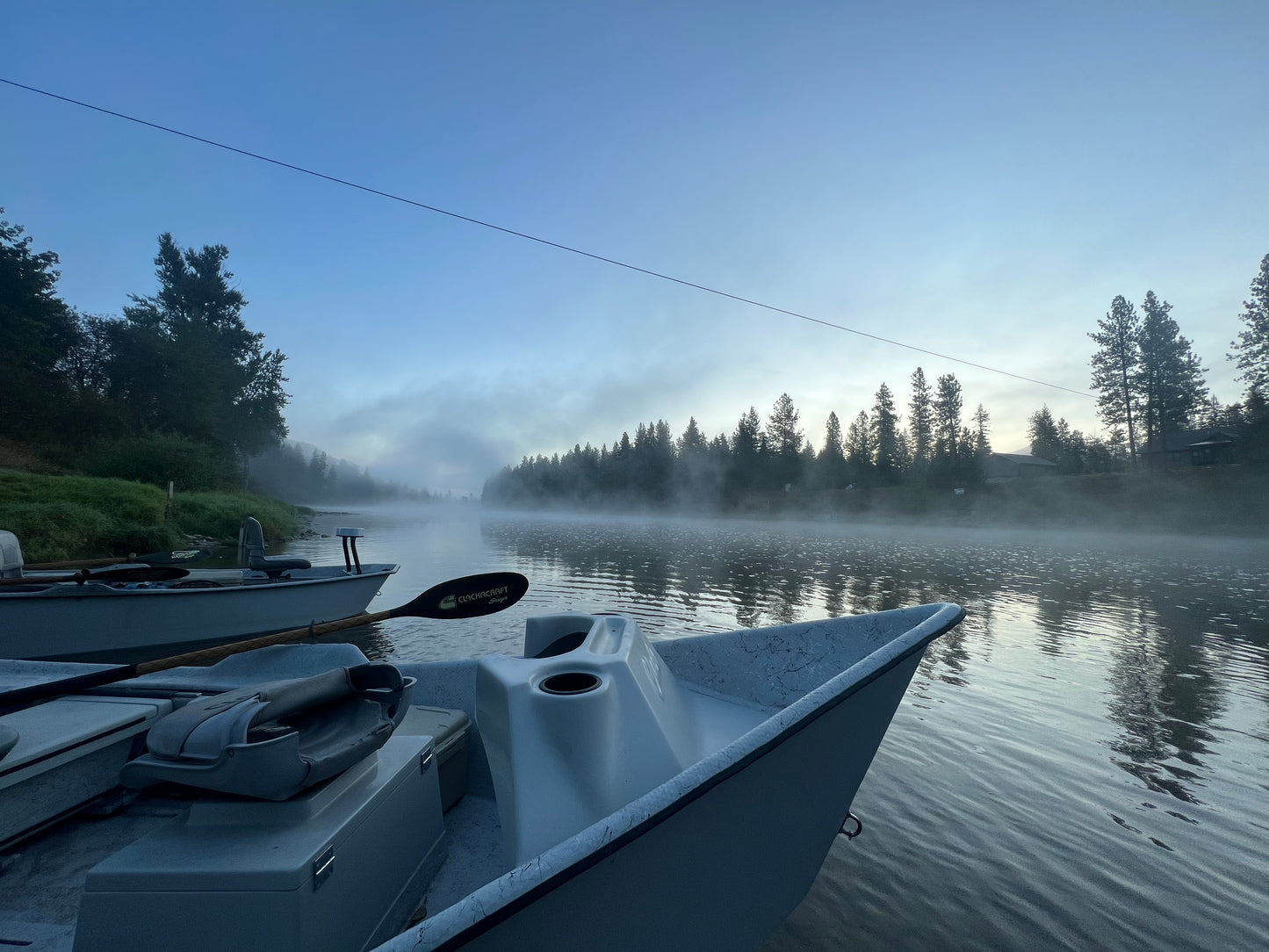 Drift Boat on a misty morning with trees in the background
